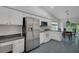 Kitchen featuring stainless steel appliances, white cabinets, and granite countertops at 32942 Rambling Oaks Ct, Leesburg, FL 34748