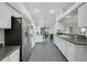 Open kitchen with stainless steel refrigerator and a connected dining area at 32942 Rambling Oaks Ct, Leesburg, FL 34748