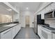 Well-lit kitchen featuring stainless steel appliances and white cabinetry at 32942 Rambling Oaks Ct, Leesburg, FL 34748