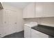 Laundry room with washer, dryer, and overhead cabinets at 32942 Rambling Oaks Ct, Leesburg, FL 34748