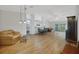 Open-concept living space with wood floors, light fixtures, and ample natural light at 32942 Rambling Oaks Ct, Leesburg, FL 34748