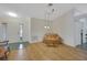 Living room with hardwood floors, natural light, and neutral walls at 32942 Rambling Oaks Ct, Leesburg, FL 34748