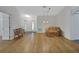 Bright living room features laminate wood flooring and neutral paint at 32942 Rambling Oaks Ct, Leesburg, FL 34748