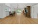 Open-concept living and dining area with wood flooring at 32942 Rambling Oaks Ct, Leesburg, FL 34748