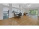 Open-concept dining and living areas with hardwood floors and lots of natural light at 32942 Rambling Oaks Ct, Leesburg, FL 34748