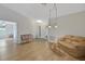 Bright living room features laminate wood flooring and neutral paint at 32942 Rambling Oaks Ct, Leesburg, FL 34748