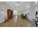 A large living room and dining room with wood-look flooring and plenty of natural light at 32942 Rambling Oaks Ct, Leesburg, FL 34748
