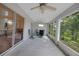 Screened patio with fan and comfortable seating to enjoy the private backyard at 32942 Rambling Oaks Ct, Leesburg, FL 34748