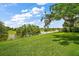 Spacious backyard featuring a serene lake view at 3393 Woodridge Dr, The Villages, FL 32162