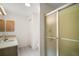 Bathroom featuring a vanity, a frosted glass shower enclosure, and neutral finishes at 3393 Woodridge Dr, The Villages, FL 32162