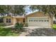 Charming home featuring an attached two-car garage and a well-maintained landscaped front yard at 3393 Woodridge Dr, The Villages, FL 32162