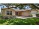 Attractive home featuring a well-manicured lawn and tasteful landscaping, enhancing curb appeal at 3393 Woodridge Dr, The Villages, FL 32162