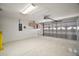 Spacious garage with epoxy flooring, overhead lighting, and a paneled garage door at 3393 Woodridge Dr, The Villages, FL 32162