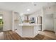 Bright kitchen featuring an island, stainless steel appliances, and modern finishes at 3393 Woodridge Dr, The Villages, FL 32162