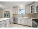 Well-appointed kitchen with white cabinets, stainless steel appliances, and a breakfast bar at 3393 Woodridge Dr, The Villages, FL 32162