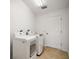 Laundry room with full size washer and dryer, bright lighting, and tile floor at 3393 Woodridge Dr, The Villages, FL 32162