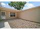Side yard featuring neutral vinyl siding and bark at 3393 Woodridge Dr, The Villages, FL 32162