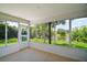 Bright sunroom with scenic views of the surrounding lush greenery and tranquil lake at 3393 Woodridge Dr, The Villages, FL 32162