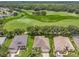 Aerial view of a home near a lush green golf course with mature trees and manicured lawns at 3507 Arlington Ridge Blvd, Leesburg, FL 34748