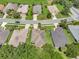 Aerial view of homes on a street with lush lawns, near the golf course and mature trees at 3507 Arlington Ridge Blvd, Leesburg, FL 34748
