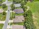 Aerial view of houses in a neighborhood with mature trees and proximity to the golf course at 3507 Arlington Ridge Blvd, Leesburg, FL 34748