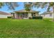 Well-maintained backyard featuring a lush lawn and a screened-in patio area at 3507 Arlington Ridge Blvd, Leesburg, FL 34748