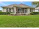 Well-maintained backyard featuring a lush lawn and a screened-in patio area at 3507 Arlington Ridge Blvd, Leesburg, FL 34748