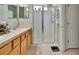 Bathroom showing a walk-in shower and a double vanity with granite countertops at 3507 Arlington Ridge Blvd, Leesburg, FL 34748