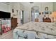 Inviting bedroom showcasing light gray floors and decor with glimpses of the bathroom and hallway at 3507 Arlington Ridge Blvd, Leesburg, FL 34748