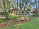 Charming community green featuring park bench seating and lush landscaping near clubhouse at 3507 Arlington Ridge Blvd, Leesburg, FL 34748