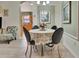 Bright dining area featuring a round table, stylish chairs, and neutral color scheme at 3507 Arlington Ridge Blvd, Leesburg, FL 34748