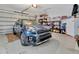 A clean and organized garage featuring a modern blue SUV at 3507 Arlington Ridge Blvd, Leesburg, FL 34748