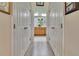 Hallway view of bathroom featuring double doors and light gray flooring at 3507 Arlington Ridge Blvd, Leesburg, FL 34748