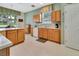 Functional kitchen featuring light wood cabinetry, ample counter space, and modern appliances at 3507 Arlington Ridge Blvd, Leesburg, FL 34748
