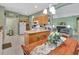 Inviting kitchen with wood cabinetry, appliances, and a view into the adjacent living area at 3507 Arlington Ridge Blvd, Leesburg, FL 34748