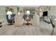 Spacious living room with hardwood floors, comfortable seating, and view to the backyard at 3507 Arlington Ridge Blvd, Leesburg, FL 34748