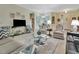 Cozy living room with modern furniture, hardwood floors, and views to dining and kitchen at 3507 Arlington Ridge Blvd, Leesburg, FL 34748