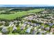Expansive aerial view of a residential area near fields and green spaces, offering serenity at 3601 Mount Hope Loop, Leesburg, FL 34748
