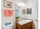 Bright bathroom featuring a sink with a gray countertop, and a white door in the corner at 3601 Mount Hope Loop, Leesburg, FL 34748