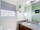 Bright bathroom featuring a soaking tub, glass block window, and decorative turtle accents at 3601 Mount Hope Loop, Leesburg, FL 34748
