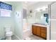 Bright bathroom with a tub, shower, and vanity with wood cabinets at 3601 Mount Hope Loop, Leesburg, FL 34748