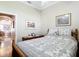 Bedroom with patterned bedding and a wooden dresser showcasing decor and artwork at 3601 Mount Hope Loop, Leesburg, FL 34748