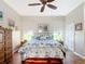 Well-lit bedroom showcasing a bed with sea-inspired bedding and hardwood floors at 3601 Mount Hope Loop, Leesburg, FL 34748