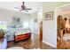 Spacious bedroom with a bed, wooden dresser, and hardwood floors, creating a welcoming ambiance at 3601 Mount Hope Loop, Leesburg, FL 34748