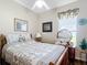 Cozy bedroom with patterned bedding, wooden furniture, a ceiling fan and a window at 3601 Mount Hope Loop, Leesburg, FL 34748
