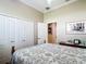 Bedroom with a closet, neutral walls, and patterned bedding on the bed at 3601 Mount Hope Loop, Leesburg, FL 34748