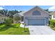 Charming single story home featuring an attached 2 car garage, manicured lawn, and inviting front entrance at 3601 Mount Hope Loop, Leesburg, FL 34748