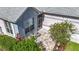 Inviting front porch with seating area, complemented by lush landscaping and a brick-paved patio at 3601 Mount Hope Loop, Leesburg, FL 34748