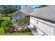 Home's exterior with lovely landscaping, garden and walkway to the front door, creating a welcoming entrance at 3601 Mount Hope Loop, Leesburg, FL 34748