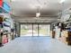 Spacious garage with overhead racks, storage shelves, and a clean, well-maintained floor at 3601 Mount Hope Loop, Leesburg, FL 34748